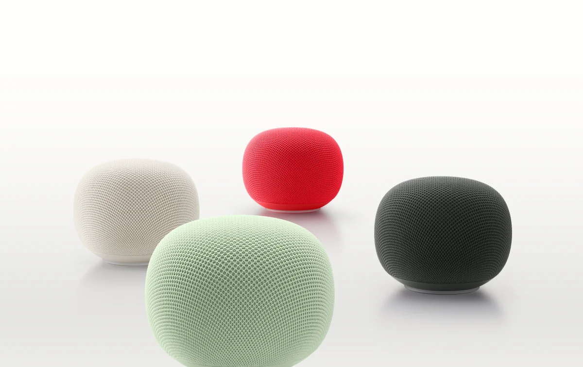 Four colorful Google Home smart speakers arranged on a white background.