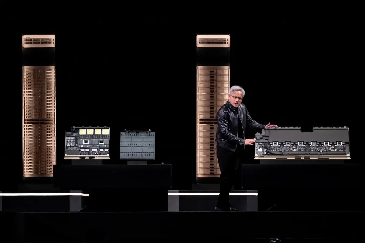 Nvidia executive presenting advanced server rack and processor architecture hardware.