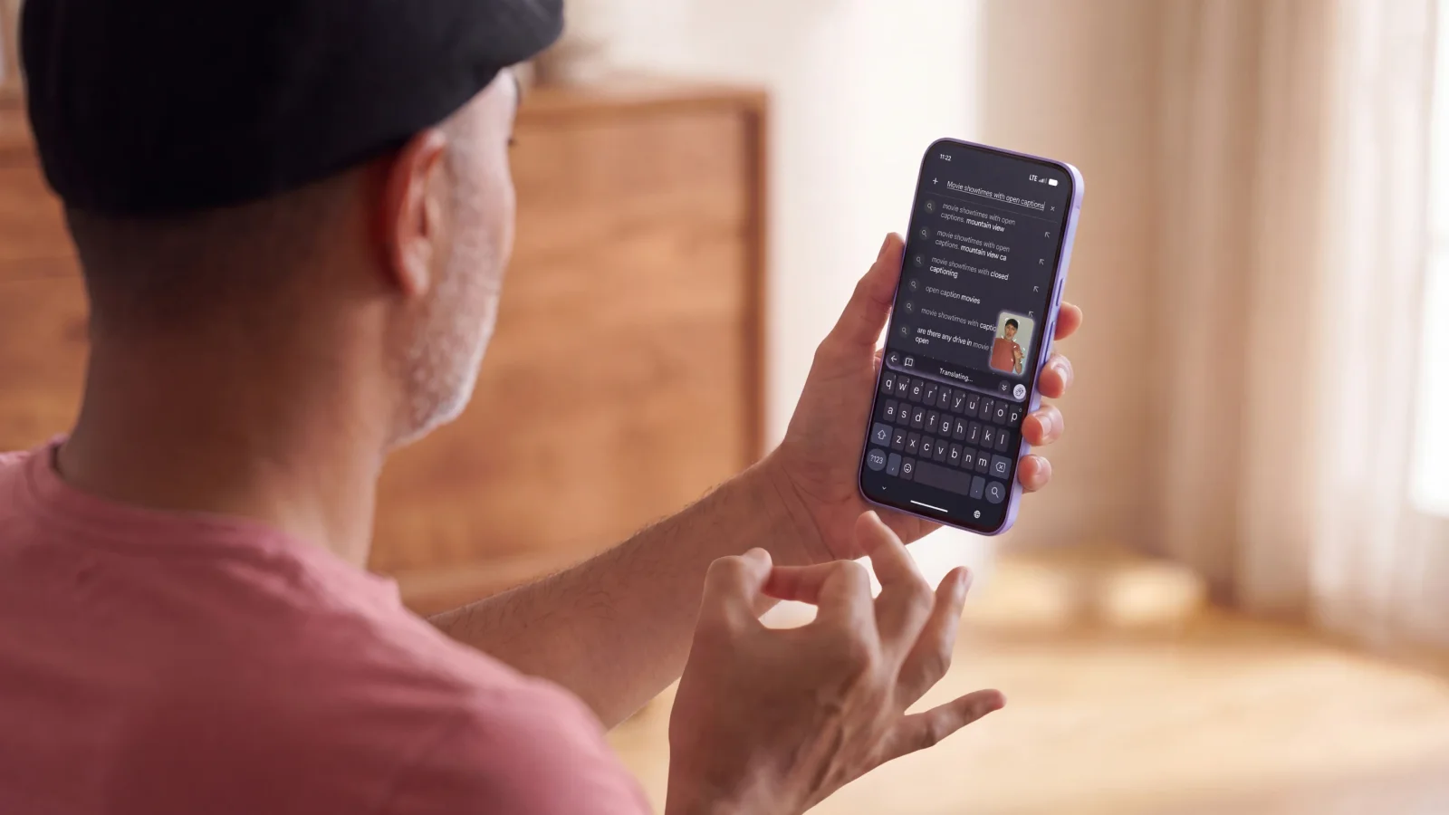 Close-up of a mobile phone displaying real-time text transcription from sign language input.