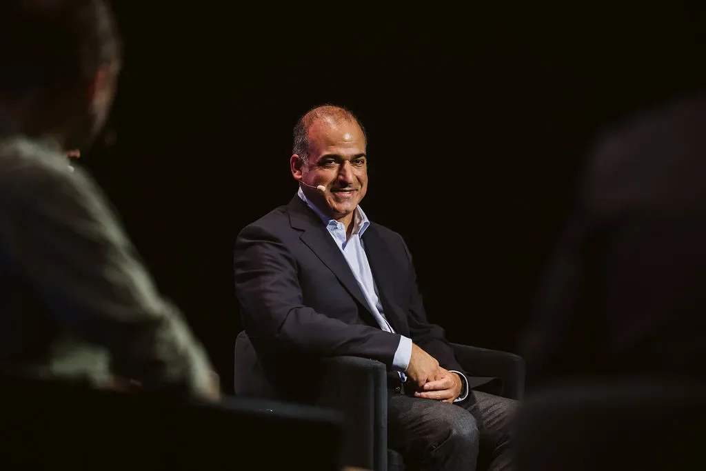 Michael Rabbat sitting on a stage during an event.